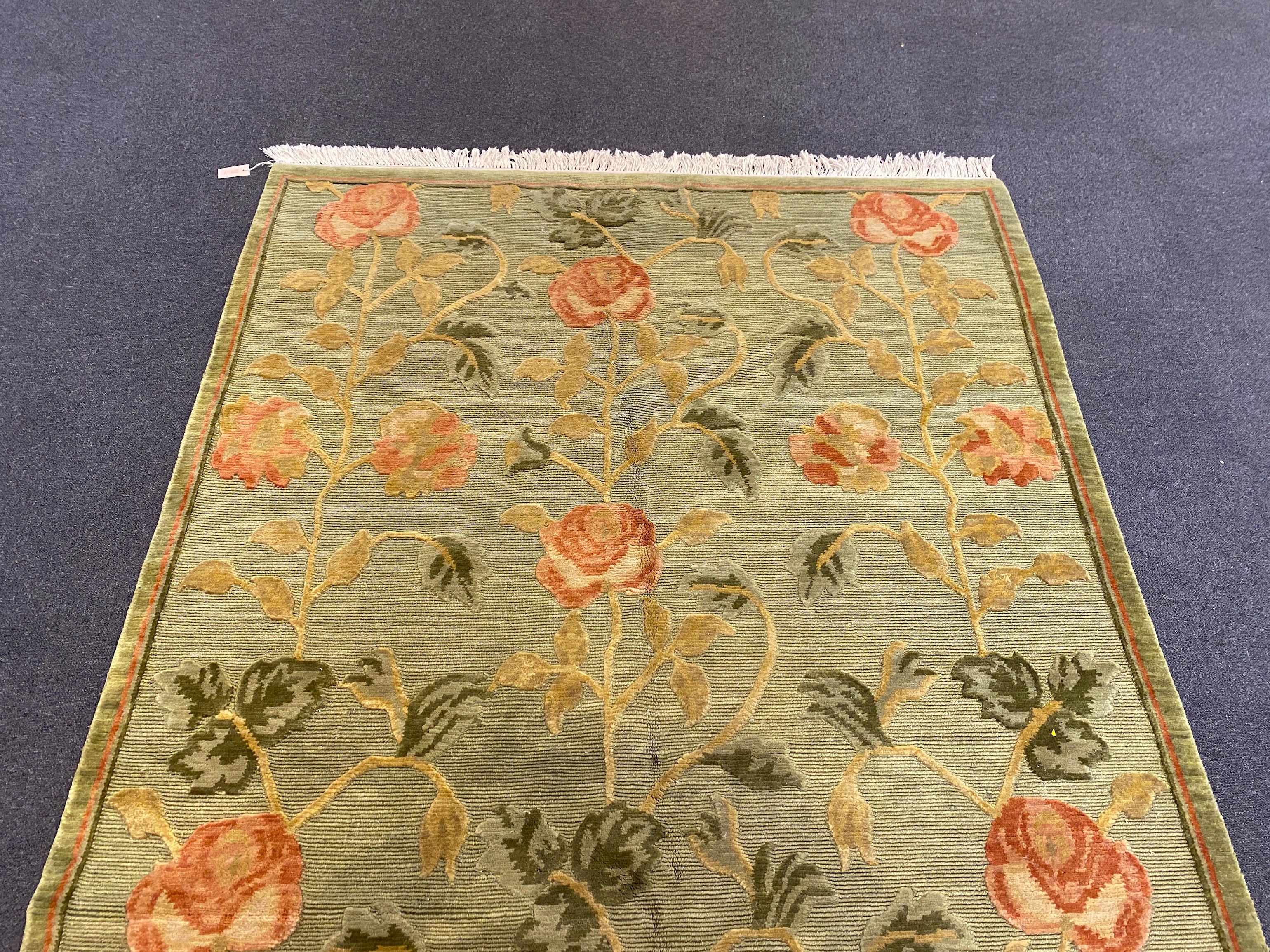 A Tibetan pale green ground carpet, 250cm x 176cm